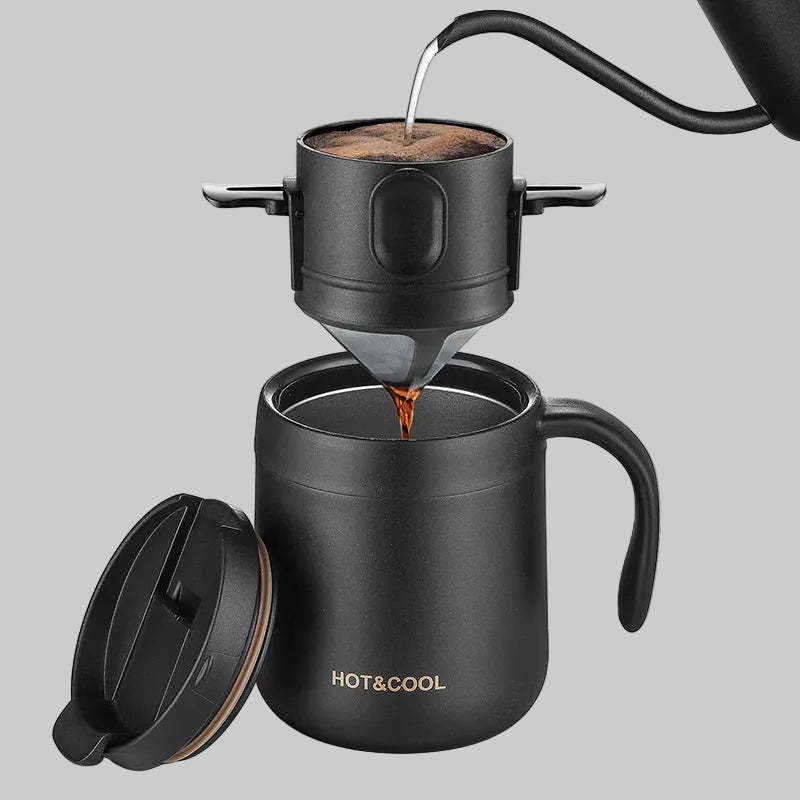 Black coffee maker with a mug, coffee beans, and leaves on a white background
