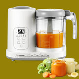 White baby food maker with a glass container filled with orange juice, surrounded by vegetables and jars of baby food.