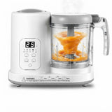 White multi-functional electric blender and food processor with a clear container showing orange puree, on a white background.