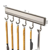 Metal hook rack with hooks on a beige background