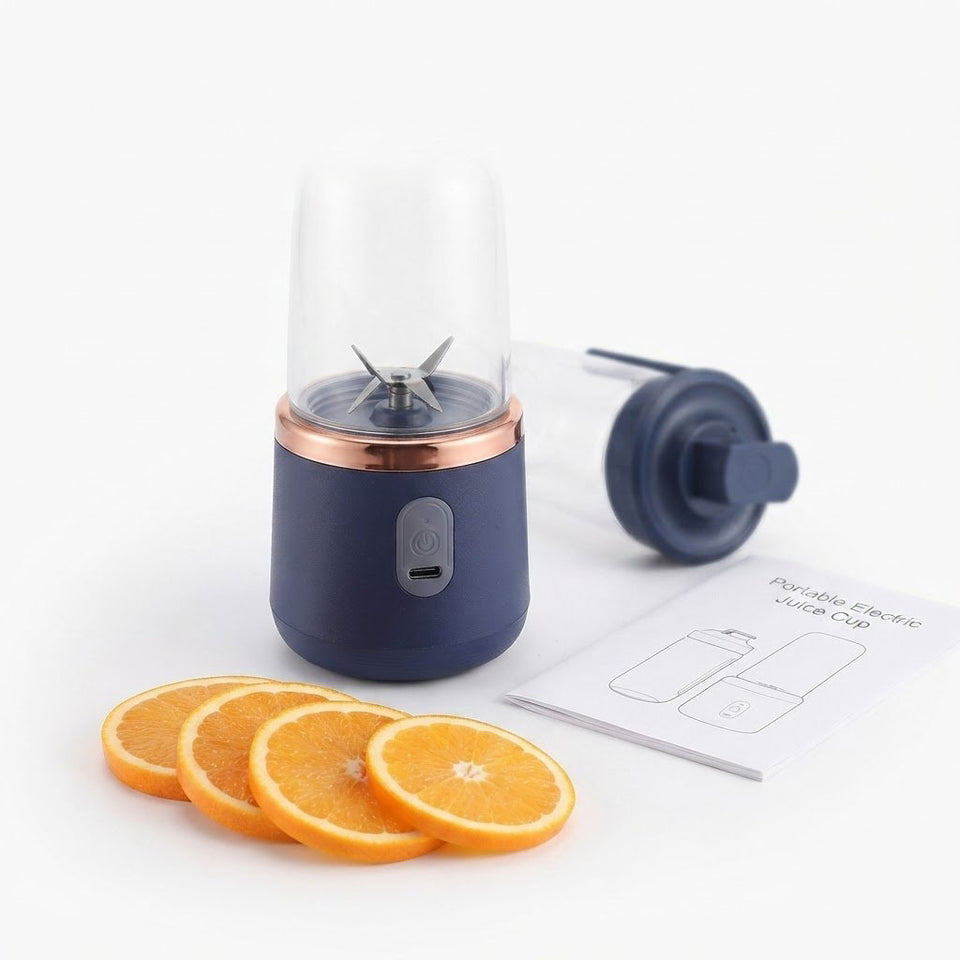 Portable USB blender blending fresh orange slices, showing juice preparation
