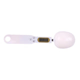 Digital scale with a white ball on a white background