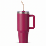 A matte magenta pink insulated travel tumbler with a handle, clear lid, and beige straw, shown on a clean white background.